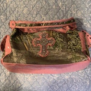 Studded pink and camo handbag with cross design.